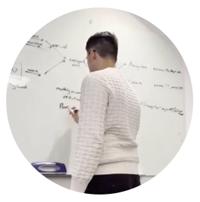 Carlos works on an equation at a whiteboard